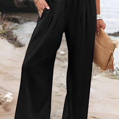 Pantalones anchos para playa Aileen de Warszawska Elegancja, pantalones de verano con estilo relajado y cómodo en color claro.