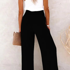 Pantalones relax de la marca Warszawska Elegancja con cintura alta, en color neutro, en un fondo blanco.