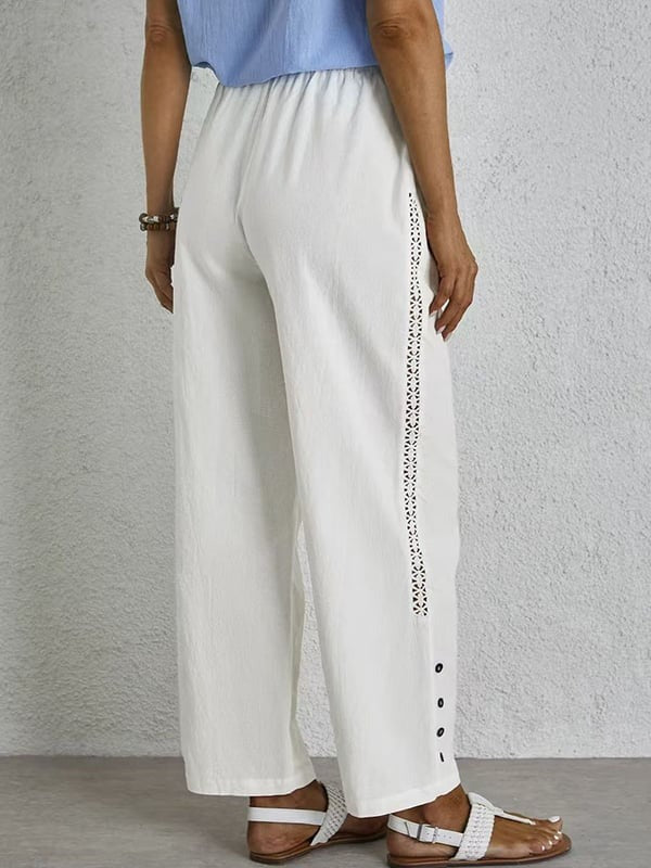 Pantalones relax con botones de la marca Warszawska Elegancja, estilo casual y cómodo, en color neutro, vista frontal.