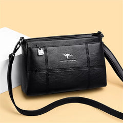 Bolso bandolera Joanna de Warszawska Elegancja con compartimentos y diseño elegante en cuero negro.