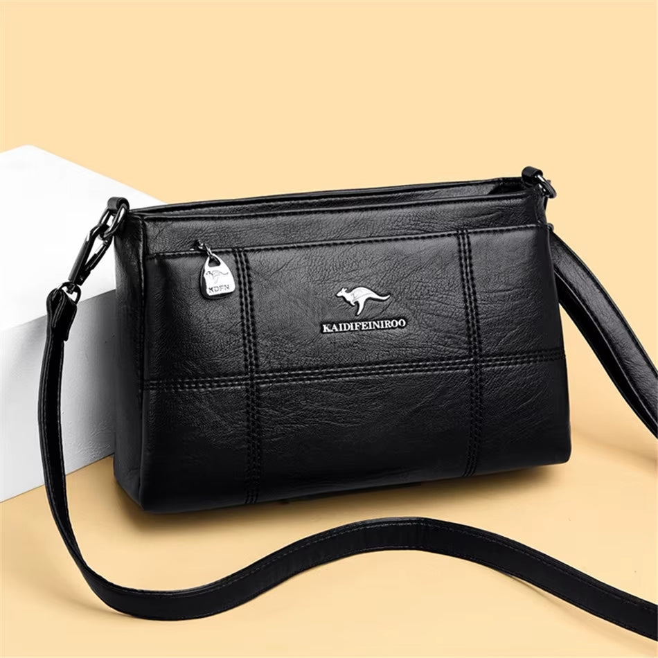 Bolso bandolera Joanna de Warszawska Elegancja con compartimentos y diseño elegante en cuero negro.