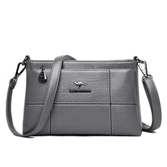 Bolso bandolera Joanna de Warszawska Elegancja, con compartimentos, en cuero negro y diseño elegante.