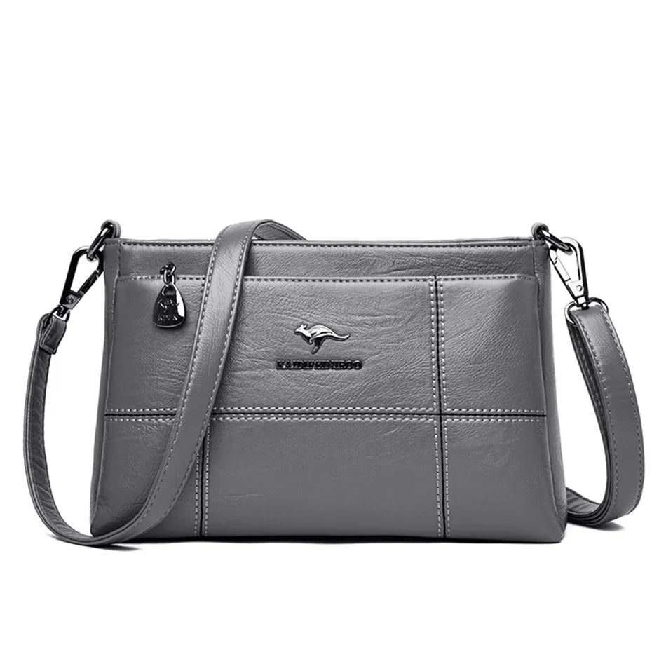 Bolso bandolera Joanna de Warszawska Elegancja, con compartimentos, en cuero negro y diseño elegante.