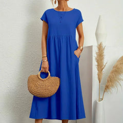 Vestido Irena de Warszawska Elegancja, diseño ligero y femenino, con detalles elegantes y corte favorecedor en color neutro.