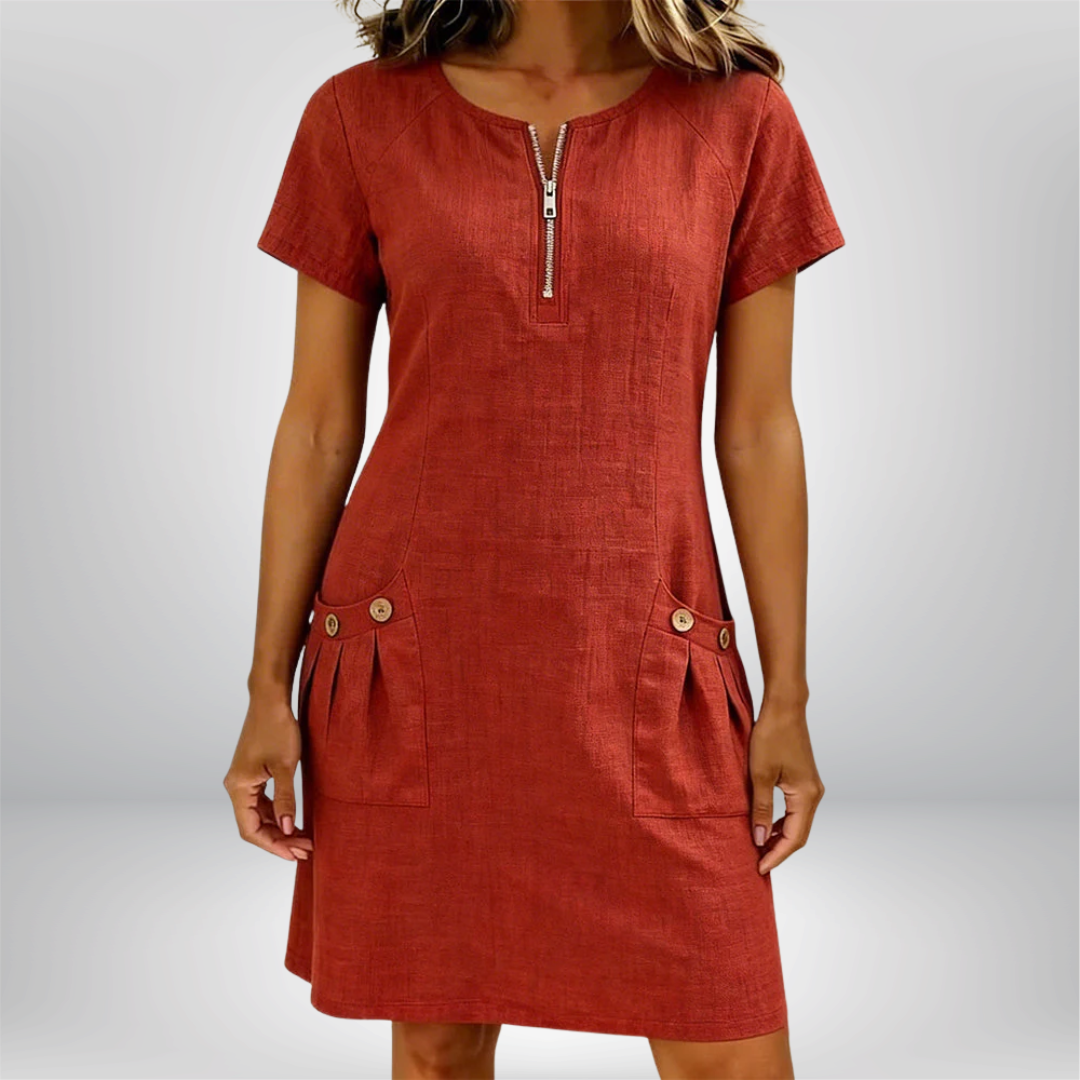 Vestido de lino de Marika con bolsillos y cierre en la parte delantera, estilo casual y elegante, en color neutro.