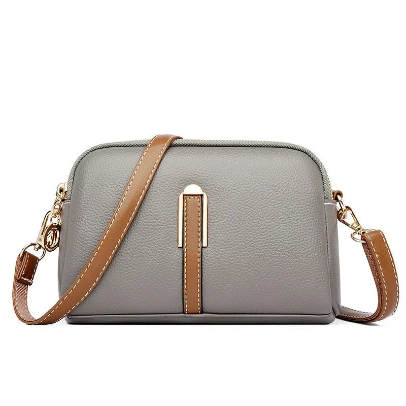 Bolsa de cuero Nina de Warszawska Elegancja en color azul con diseño elegante y detalles en gris, para mujer.