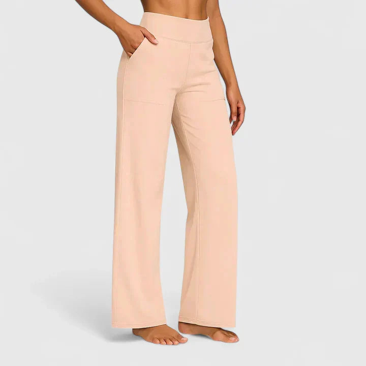 Pantalones elegantes Ame de Warszawska Elegancja en color durazno, con corte recto y tela suave, vista frontal.