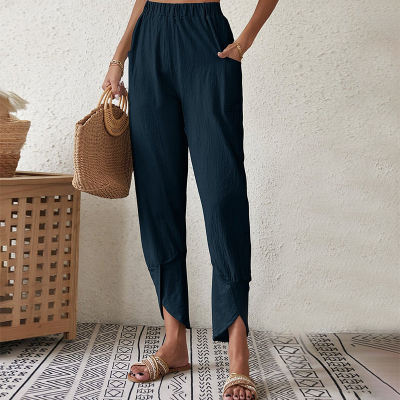 Pantalones de mujer Essari con dobladillo crudo de la marca Warszawska Elegancja en color oscuro, vista frontal con detalles de costura.